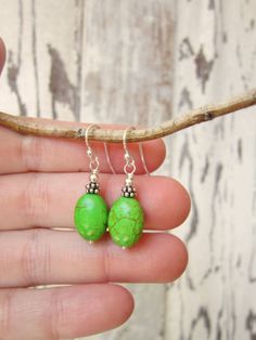 "These simple dangle earrings are made from green turquoise oval howlite stones. A very pretty color of apple green turquoise. They are accented with Bali silver spacers and sterling finishing beads. They measure 1 1/8\" from the top of the sterling silver earwires. Make it a set, see the matching NECKLACE here: https://www.etsy.com/listing/240376982/triple-strand-green-turquoise-necklace?ref=shop_home_active_21 All my jewelry comes gift boxed with a bow ready for gift giving whether it is a gif Hypoallergenic Turquoise Oval Earrings, Green Oval Earrings With Natural Stones, Oval Green Earrings With Natural Stones, Green Oval Hypoallergenic Earrings, Hypoallergenic Green Oval Earrings, Green Oval Nickel-free Earrings, Simple Dangle Earrings, Howlite Jewelry, Turquoise Dangle Earrings