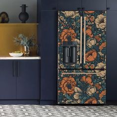 a kitchen with blue cabinets and floral wallpaper on the door, along with a coffee maker