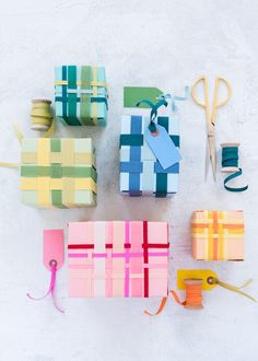 several different colored boxes with scissors and thread