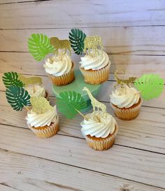 cupcakes with white frosting and gold decorations