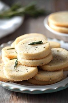 a plate full of crackers with rosemary on top