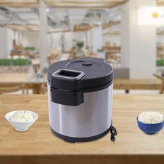 an image of a kitchen setting with rice in the bowl and coffee mugs on the table