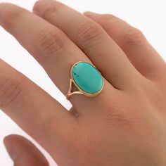 A one of a kind ring with a large, natural, turquoise cabochon from the Sleeping Beauty mine. The ring is made of solid 14k yellow gold. The simple ring design displays the natural beauty of the turquoise. Ring size 8. Dimensions: The turquoise is 16x12mm. The face of the ring is 17x13mm. The ring band tapers from 8mm at the shoulders to 1.25mm in the center back.  Handmade in the USA. Fine Jewelry Turquoise Ring With Oval Cabochon, Turquoise Opal Ring With Oval Cabochon, Fine Jewelry Turquoise Cabochon Ring In 14k Gold, Fine Jewelry 14k Gold Turquoise Cabochon Ring, 14k Gold Turquoise Cabochon Ring, Blue Oval Cabochon Turquoise Ring In 14k Gold, Blue Turquoise Oval Cabochon Ring In 14k Gold, 14k Gold Blue Oval Cabochon Turquoise Ring, Turquoise Oval Cabochon Ring