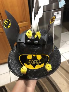 a cake decorated to look like a batman with yellow chicks on it and the words happy easter