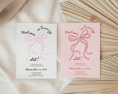 two wedding cards with bows on them sitting on top of a white bedding sheet