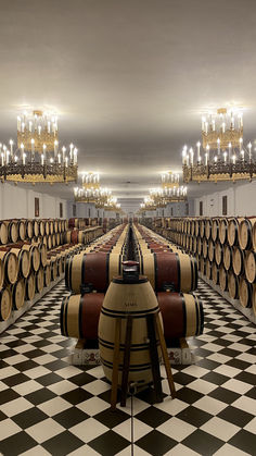 a room filled with lots of barrels and chandeliers