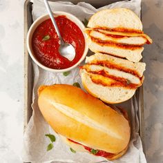 a sandwich and some sauce on a tray