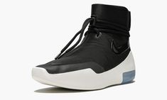 The Nike Air Fear of God Shoot Around is one of two models released within the debut FOG x Nike collection in 2018.  While there are similarities between this silhouette and the high-profile Fear of God 1, the Fear of God Shoot Around is designed with a more minimalist upper devoid of the TPU “cage” in favor of a sleek all-black material with a lacing system and strap that both wrap the ankle.  The upper sits atop a sculpted foam sole with a visible Zoom Air unit in the heel.  The result is an i Nike Air Fear Of God, Nike Collection, The Fear Of God, African Royalty, Stadium Goods, Fear Of God, The Fear, Nike Air Zoom, Wedge Sneaker