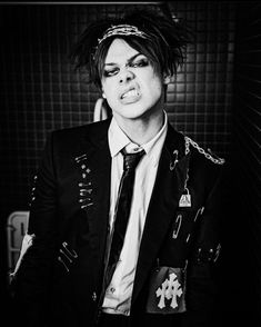 black and white photograph of a man with dreadlocks on his head wearing a suit