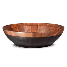 a wooden bowl sitting on top of a white table