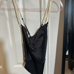 Super Cute Satiny Black Bodysuit With Faux Pearl Spaghetti Straps! Never Worn, Brand New With Tags, Size Small Chic Bodysuit With Built-in Bra For Night Out, Chic Bodysuit With Built-in Bra For Evening, Trendy Party Swimwear With Spaghetti Straps, Chic Bodysuit With Spaghetti Straps, Chic Cami Bodysuit For Party, One-piece Bodysuit With Built-in Bra For Night Out, Chic Spaghetti Strap Bodysuit For Date Night, Trendy Backless Camisole For Night Out, Elegant Cami Bodysuit For Party