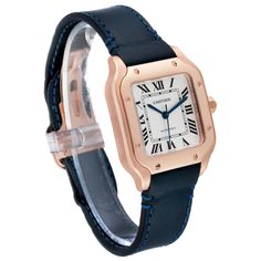 Cartier Santos Midsize Rose Gold Blue Strap Mens Watch WGSA0012 Box Card. Automatic self-winding movement caliber 1847 MC. 18K rose gold 35.1 x 35.1 mm. Protected octagonal crown set with the blue faceted sapphire. 18K rose gold bezel punctuated with 8 signature screws. Scratch resistant sapphire crystal. Silvered opaline dial with radial Roman numerals. Inner minute track. Luminous sword-shaped blued steel hands. Secret Cartier signature at VII. Blue leather strap with 18K rose gold deployant c Mens Designer Watches, Men's Watches Luxury, Cartier Ballon Bleu, Patek Philippe Aquanaut, Cartier Santos, Rolex Air King, Cartier Men, Alexandra Daddario, Box Card