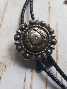 "The bolo tie isn't just for cowboys. It is being worn by presidents to rock stars and actors. They have become a fashion statement with men and women. Our bolos are made with real leather cord, not the inexpensive vinyl or cloth cord. They are 36\" or 40\" long without the tips. The concho is attached to a bolo slide that locks the cord where you want it to stay. The bolo tie is the official neckwear for the states of Arizona, New Mexico, and Texas" State Of Arizona, Bolo Ties, Buffalo Nickel, Bolo Tie, Rock Stars, Tie Accessories, San Antonio Tx, Suit And Tie, Leather Cord