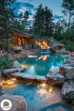 an outdoor swimming pool surrounded by rocks and water features a gazebo with lights on it