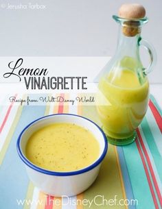 a bowl of soup next to a bottle of lemon vinaigrette