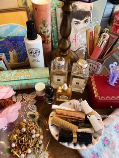 a table topped with lots of different types of cosmetics and personal care items on top of it