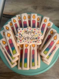 birthday cookies decorated with candles on a plate