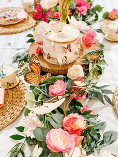 a table topped with a cake covered in flowers