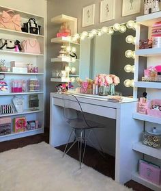 a room with a desk, mirror and shelves filled with cosmetics on top of it