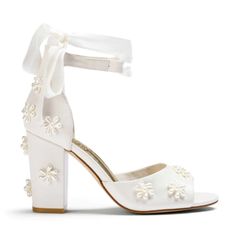 a white high heeled shoe with flowers on it