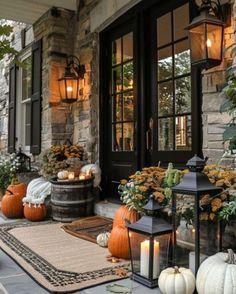 the front porch is decorated with pumpkins and lanterns