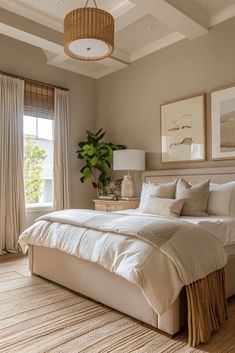 a large bed in a bedroom next to a window with curtains on both sides and a basket hanging from the ceiling