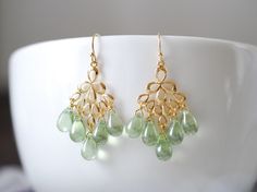 Mint Green Czech Glass Beads Gold Chandelier Earrings. Mint is one of my favorite colors, and I created this earrings for my favorite season -summer :) Each small Czech teardrop glass bead is individually, carefully wire wrapped and connected to gorgeous gold peacock feather pendants. Mint glass bead measures 9mm x 6mm. Total length of these earrings is approx. 1.9 inches (48mm) including gold plated French hook ear wires. These earrings can be made with glass drops in different colors upon your Green Pearl Earrings, Feather Chandelier, Gold Peacock, Gold Orchid, Sparkling Jewelry, Gold Chandelier Earrings, Minty Fresh, Beautiful Accessories, Fancy Stones