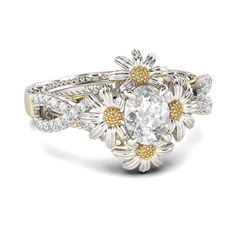 a white and yellow gold ring with an oval diamond surrounded by small flowers on the band