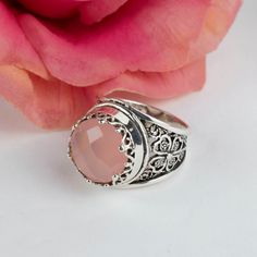 Discover Timeless Elegance with Our Pink Chalcedony Gemstone Filigree Art Silver Ring Elevate your style with our exquisite Pink Chalcedony Gemstone 925 Sterling Silver Artisan-Made Handcrafted Filigree Art Ring. Designed with a charming Four Leaf Clover Motif, this ring carries a deeper symbolism. The four-leaf clover is renowned as a symbol of good luck, with each leaf representing a unique facet of positivity: hope, faith, love, and luck. Discover your own stroke of fortune as you embrace the enchantment of this stunning piece. The Pink Chalcedony gemstone, with its 12 mm faceted proud cut, takes center stage, adding a touch of elegance and grace to this already mesmerizing creation. It's a gemstone that embodies soothing and calming energies, making it a symbol of positivity and tranqu Silver Filigree Ring With Stone Setting For Wedding, Silver Filigree Ring With Stone Setting, Exquisite Silver Filigree Ring In Sterling Silver, Silver Sterling Filigree Ring With Stone Setting, Exquisite Silver Filigree Ring Gift, Gift Filigree Ring With Stone Setting, Silver Filigree Ring With Stone Setting For Gift, Exquisite Filigree Ring With Gemstone, Exquisite Gemstone Filigree Ring As A Gift