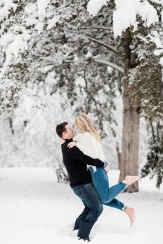 a man and woman hugging in the snow