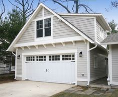 a house with two garages and an attached porch