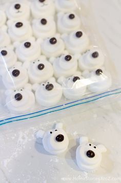 there are some white frosted donuts with black eyes in the shape of bears