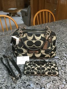 Up for Sale: Coach Kristen Signature Double Zip Satchel With Matching Wallet. Style No: F22305 Condition: Brand new with tags Color: Black/White/Black Retail: Satchel -$378.00 Wallet-$250.00 Size: 12” length x 8” height x 5” deep Handles: Black Leather rolled handles with 5” drop. Also has detachable longer shoulder strap. (Also Black Leather) Hangtag: Yes attached Please ask all questions prior to bidding, I will answer them all promptly. Sorry I do not ship internationally. These pieces are br Designer Coach Wallets, Leather Roll, Louis Vuitton Speedy Bag, Louis Vuitton Monogram, Bags Handbags, White Black, Satchel, White And Black, Top Handle Bag