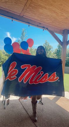 a woman holding up a sign that says be miss