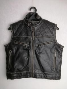 LEATHER CULT vintage men's quilted zipped vest Very good used condition Size tagged S (please check measurements) Composition: genuine leather (shell), synthetic material (lining) Measurements: Shoulder to shoulder - 16.1" / 41 cm Pit to pit - 20.9″ / 53 cm Bottom width - 19.3" / 49 cm Back length from collar - 20.9″ / 53 cm * All measurements are taken with the garment laying flat #5321 Biker Style Vest Outerwear For Biker Events, Biker Style Vest For Biker Events, Winter Biker Events Vest Outerwear, Sleeveless Leather Jacket For Biker Events, Casual Sleeveless Outerwear For Biker Events, Moto Style Sleeveless Vest For Streetwear, Moto Sleeveless Vest For Streetwear, Sleeveless Biker Leather Jacket For Biker Events, Winter Leather Motorcycling Vest