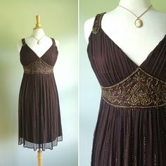 Shimmer and shine 🎆 This flapper-inspired dress features a rich brown, sheer, silk-crepe overlay with intricate copper beading; a flattering shirred, gathered bodice and jeweled straps; a floaty skirt with rows of beads accenting the pleating; and a jeweled high waist. Lined; hidden side zip. New and never worn with original store tag still attached. Fits medium sizes; pictured on a US size 6/8 dress form. Era: 1990s Label: D'Albert Fitted Vintage Brown Prairie Dress, 1920s Fitted Beaded Dress, Vintage Silk Flapper Dress Fitted, Flapper Inspired Dress, 1930s Gown, Vintage Beaded Silk Dress, Beaded Flapper Dress, Vintage Brown Hand-strung Beaded Necklace, Frilly Dresses