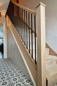 a stair case in a house with blue and white flooring