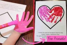 a child's hand with pink paint on it next to a valentine card