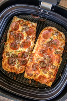 two slices of pizza sitting on top of an air fryer with text overlay