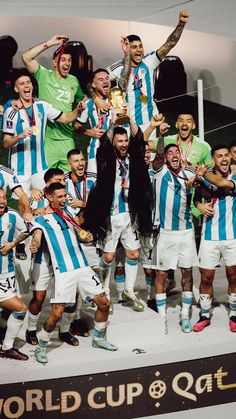 a group of men standing next to each other holding trophies