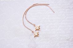 Rose Gold Star Threader Earrings, No. RGTE007 :*About This Piece*: ♦︎ Dainty and elegant, these Rose Gold Stars feature sparkling cubic zirconia and hang on rose gold filled threaders. Elegant, classy, and beautiful. ♦︎ Length - 3.5 in (90 mm) ♦︎ Pendant - .4 in (10 mm) wide ♦︎ All items from my shop are packaged in padded cardboard jewelry boxes. Custom gifting options available upon request. ♦︎ Are you looking for something specific? I love to do custom orders so please message me if you are i Rose Gold Star Earrings For Anniversary, Elegant Rose Gold Star Earrings, Cardboard Jewelry, Cardboard Jewelry Boxes, Threader Earrings, Gold Star, Jewelry Boxes, Gold Stars, Custom Orders