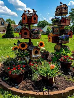 several bird houses are arranged in a flower bed