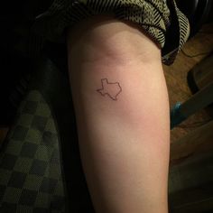 a person with a small tattoo on their arm that has the shape of a star