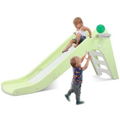 two children playing on a green slide