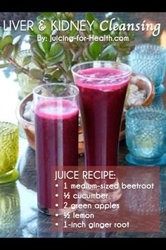 two glasses filled with juice sitting on top of a table