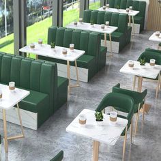 a restaurant with green booths and white tables