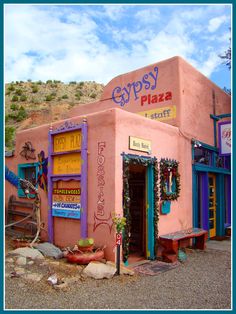 a pink building with many signs on it