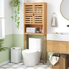 a bathroom with a toilet, sink and wooden cabinet above it's countertop