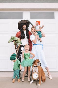 a group of people in costumes posing for a photo with a dog and two children