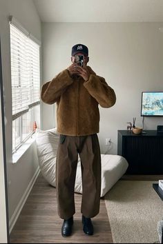 a man is taking a selfie in his bedroom